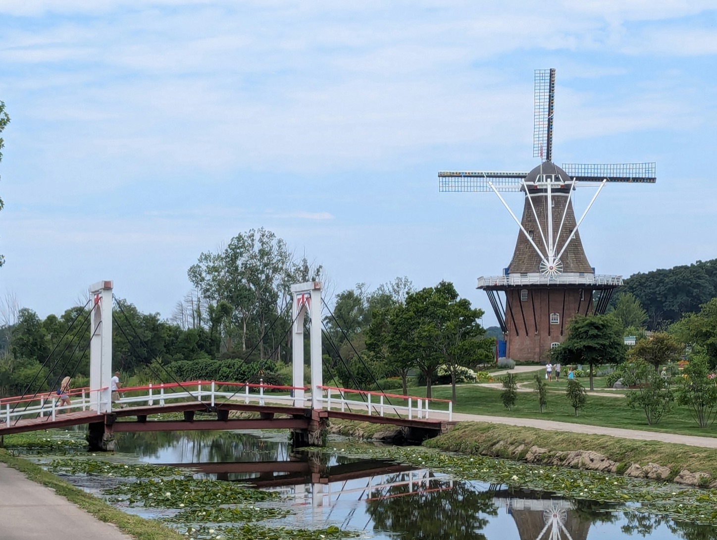 The De Zwaan windmill and a white footbridge over a canal in Holland, Michigan