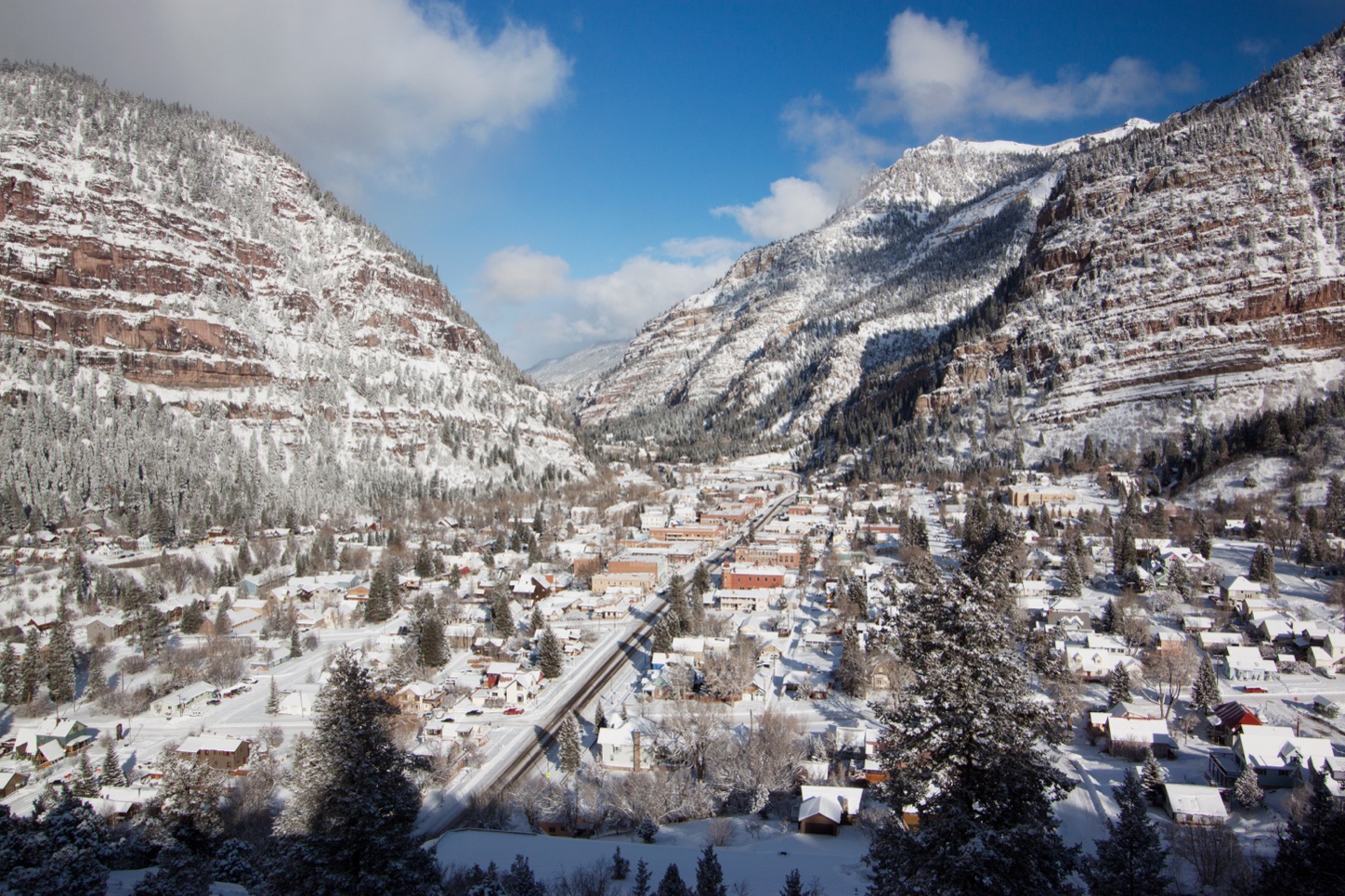 Ouray, Colorado, after a light snowfall, between red cliffs and snowy peaks