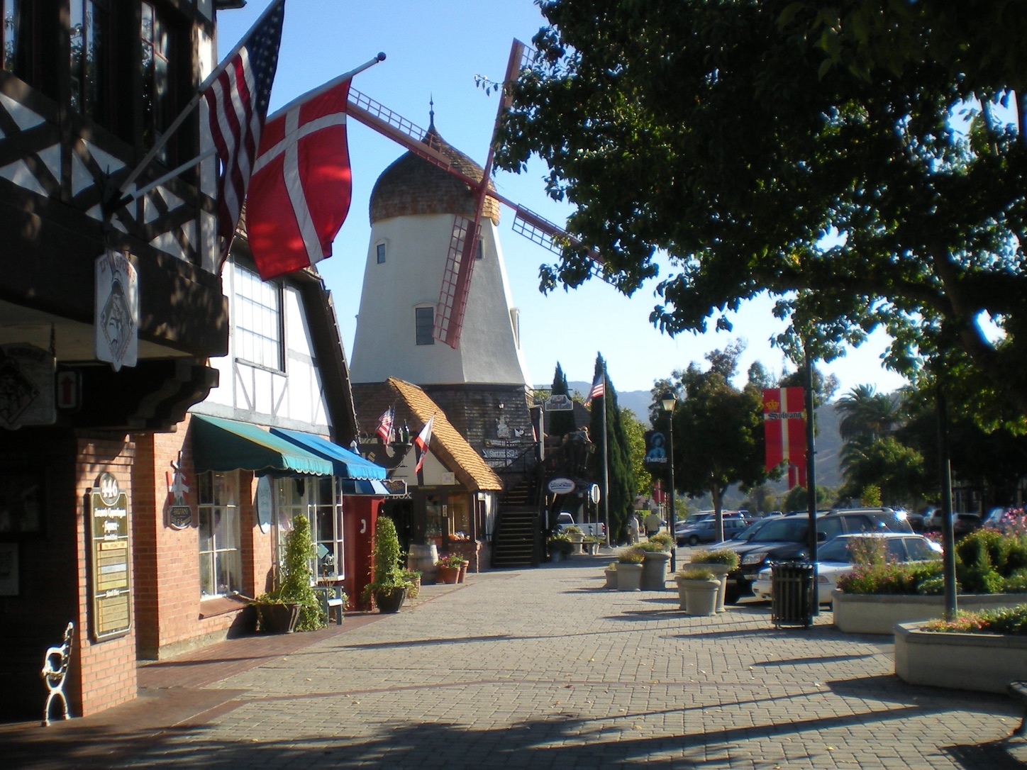 A Danish-style windmill and Danish and American flags in Solvang, California